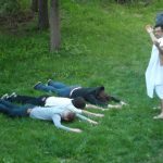 [en]: the participants lie on the grass in front of "the emperor"